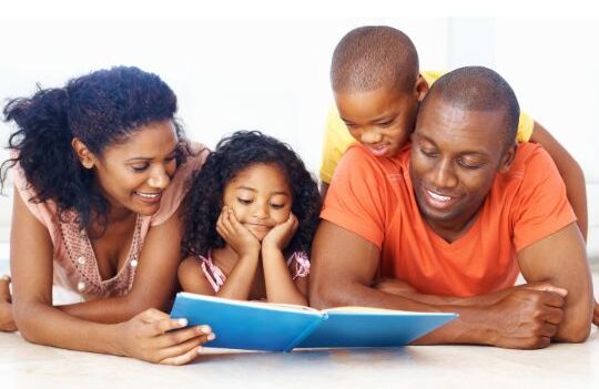 Black Parents laying on the floor reading a book with their children below the words "Miracle Mornings: A Guide for Parents/Scholars of K–12 Students"